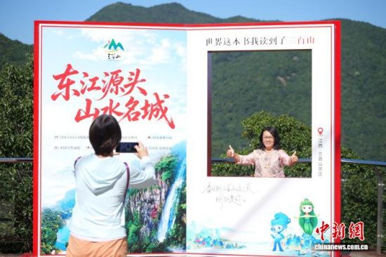图为在三百山打卡拍照的游客。 刘思婷 摄 图为在三百山打卡拍照的游客。 刘思婷 摄